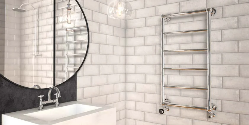 Castrads Elara chrome towel warmer on a white tiled bathroom wall