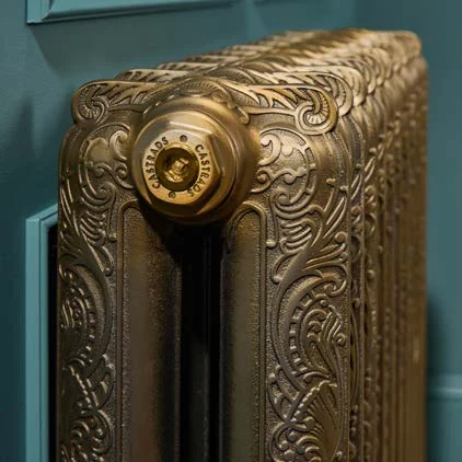 Close-up of a Castrads Rococo radiator in a hand-polished Natural Brass finish