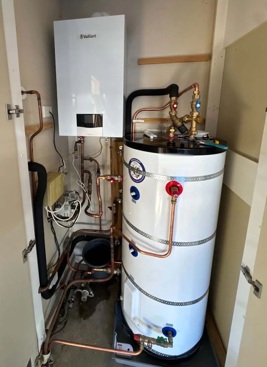 Gas boiler heating the underfloor and a hot water cylinder, fitted together in one cupboard