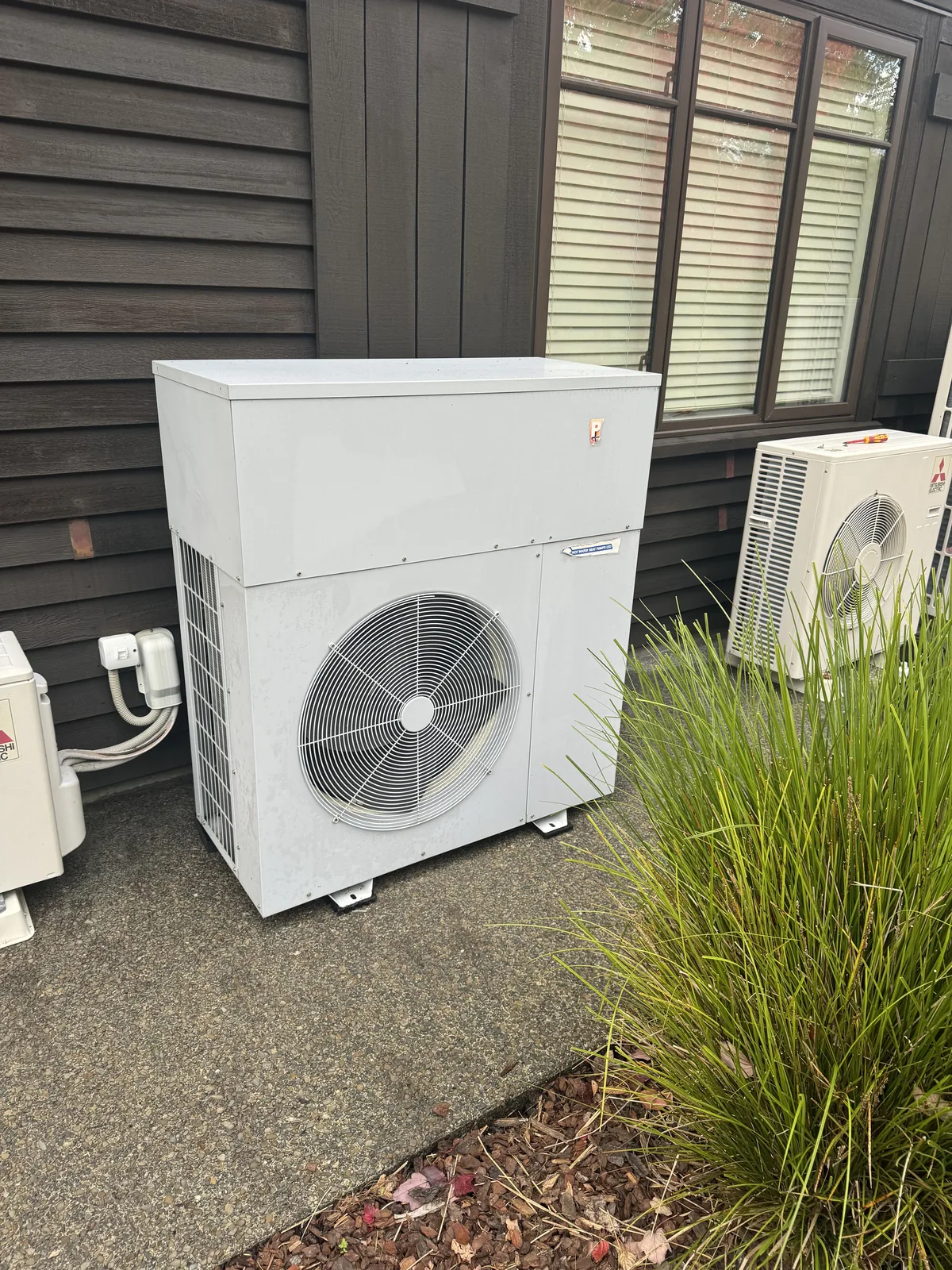 An air to water heat pump installed beside an Auckland house