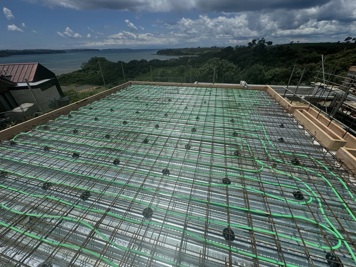 Underfloor heating pipe clipped to reinforcing mesh before the concrete pour, Auckland