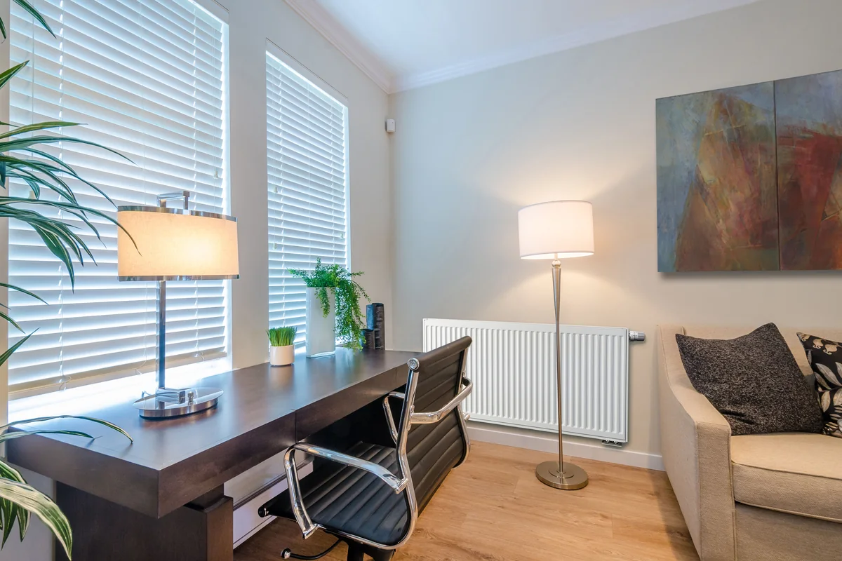 Brugman steel panel radiator beside a desk in a home office