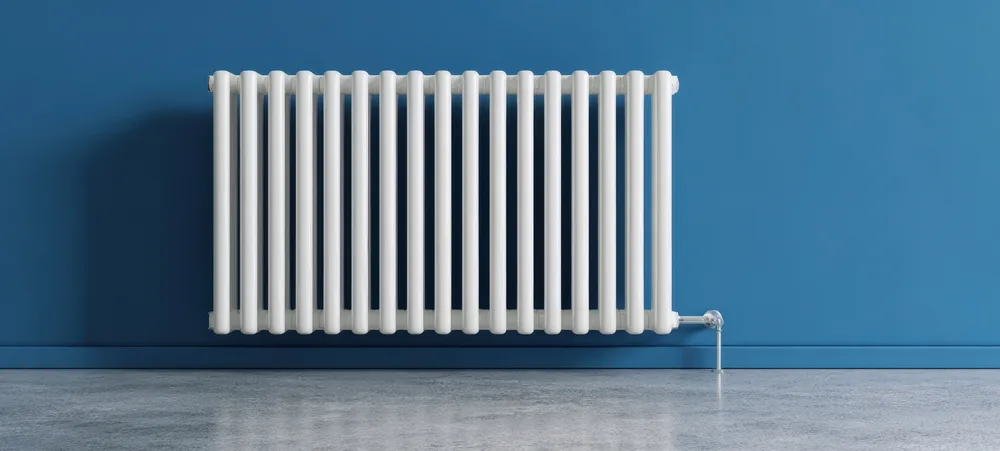 A white panel radiator in a sunlit room