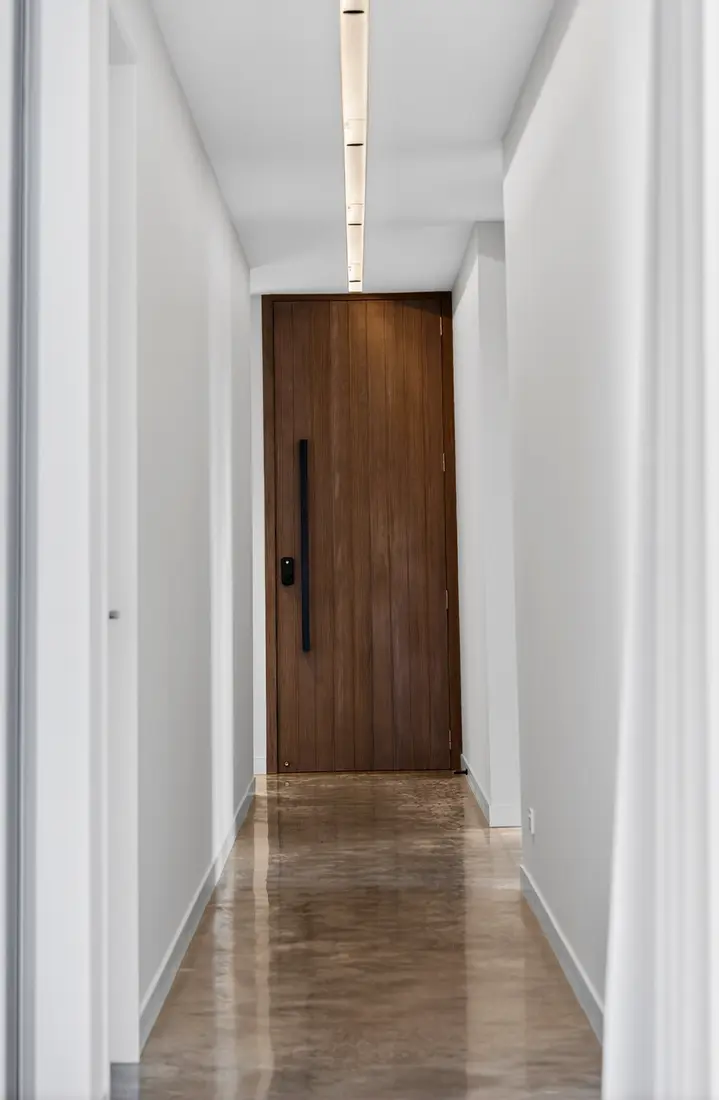 Hallway with polished concrete floor and timber door