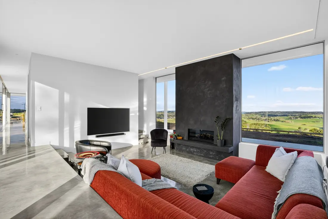 Sunken lounge with concrete fireplace